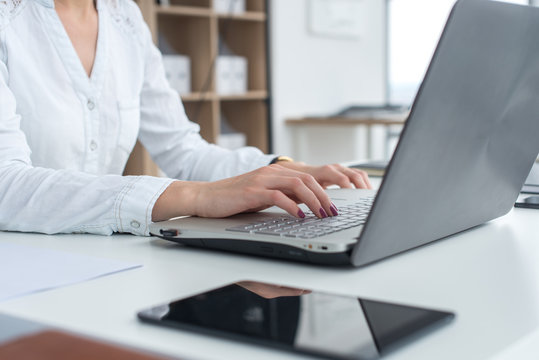 Working with laptop woman writing a blog. Female hands on the keyboard.