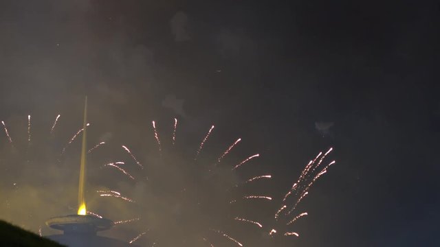 Fireworks above building with the spire at night. 4K long shot