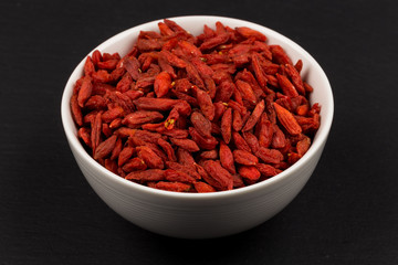white ceramic  bowl with goji berries