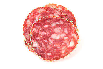 Slices of salami sausage on a white background