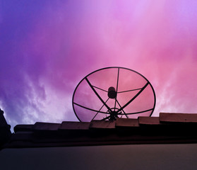 Silhouette of satellite with colorful sky sunset
