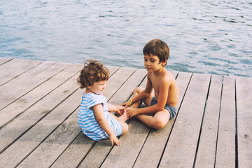 Brothers sitting on dock