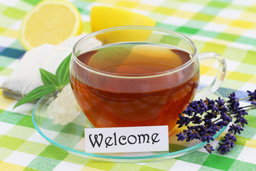 Welcome card with cup of lemon tea and lemon
