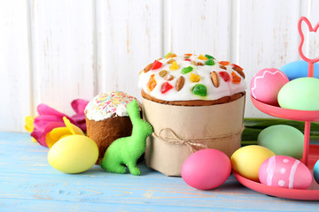 Easter eggs with cake on a blue wooden table