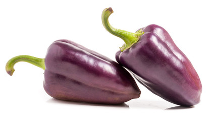 two purple peppers isolated on white background macro