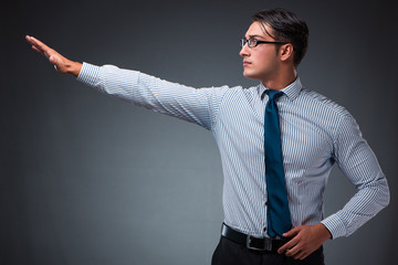 Handsome businessman pressing virtual buttons