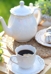 Cup of black coffee with a cookie
