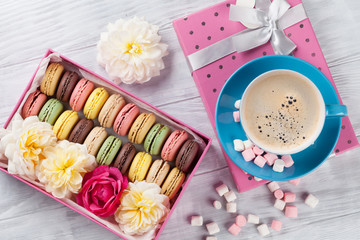 Macaroons and coffee. Sweet macarons in gift box