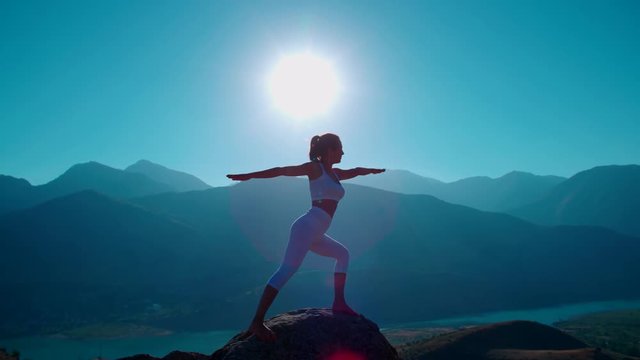 4K yoga in the mountains,the sunrise, beautiful girl in white clothes doing yoga, slow motion