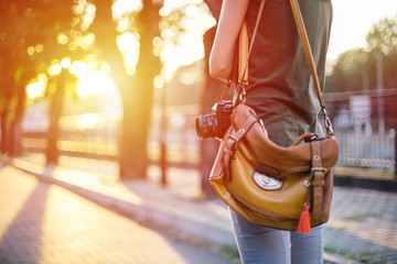 Midsection of female photographer with retro camera
