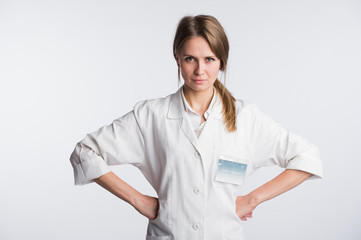 Portrait of Woman surgeon doctor in confident pose isolated over white background with hands on hips