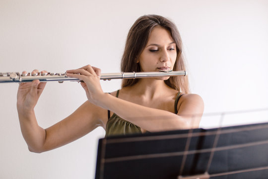 Flutist musician playing
