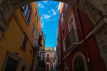 Typical street scene in the old town of Bari, with colorful buildings and clear blue sky