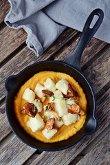 Gnocchi with pumpkin sauce and chanterelles mushrooms, top view