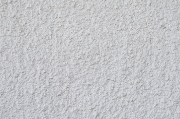 Background of a white stucco coated and painted exterior, rough cast of cement and concrete wall texture, decorative coating