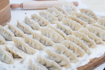 raw dumplings on the wooden desk