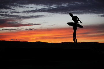 Ballet dancer posing during the sunset