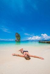 Fototapeta na wymiar Cute woman relaxing on the beach