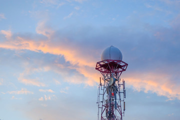 Radar dome in the sea with blue sky and clouds.