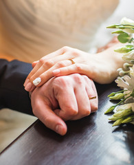 Hands of the bride and groom close-up