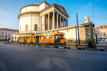 Turin cityscape view on Gran Madre square with church and old yellow tram in the morning