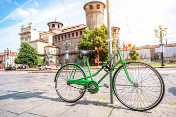 Fototapeta na wymiar Green bicycle near Madama castle in the old city center of Turin in Piedmont region in Italy