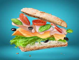 Delicious sandwich with ingredients in the air