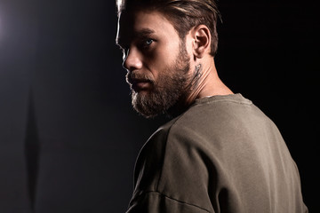 Portrait of a handsome man in profile a white t-shirt from the back