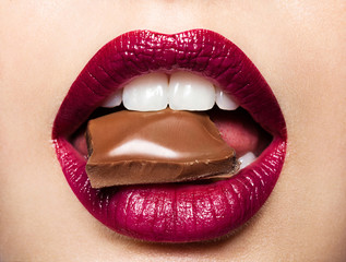 Beautiful female lips with chocolate - obrazy, fototapety, plakaty