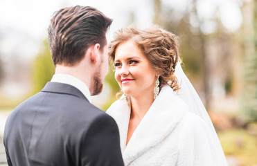 Young wedding couple enjoying romantic moments outside on autumn nature