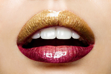 Beautiful female lips with a gradient coloring from gold to red
