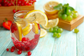 Refreshing water with fruits on table