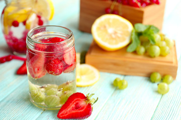 Refreshing water with fruits on table