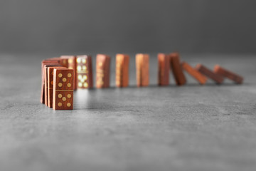 Wooden dominoes on grey table