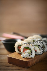Delicious sushi rolls on table