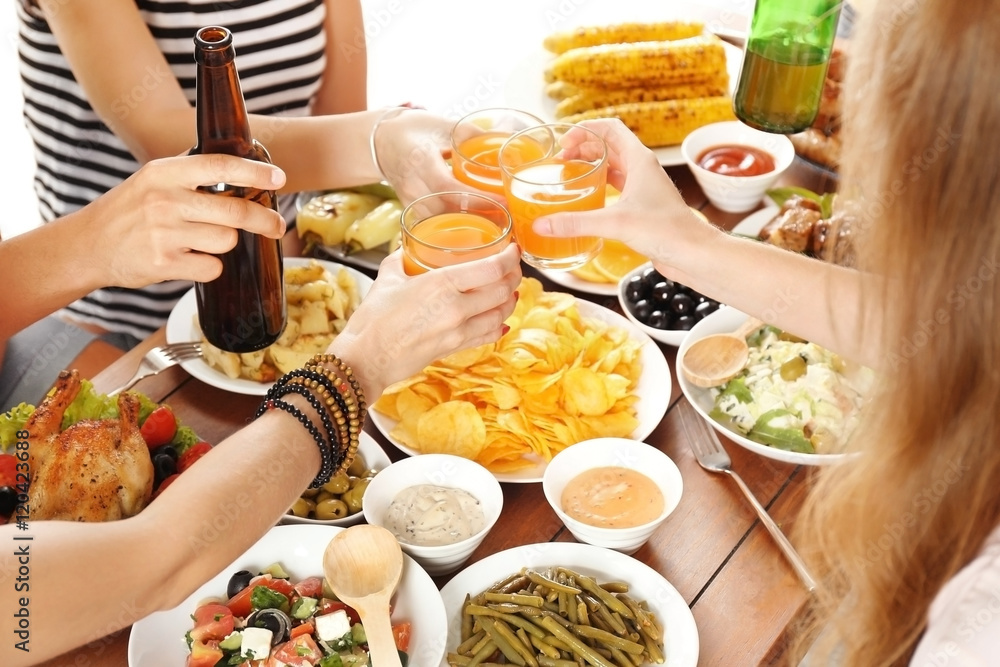 Sticker Friends cheering with orange juice and beer in restaurant