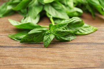 Fresh basil leaves on  wooden background