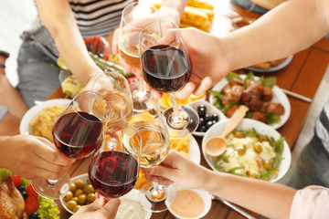 Friends cheering with glasses of wine in restaurant