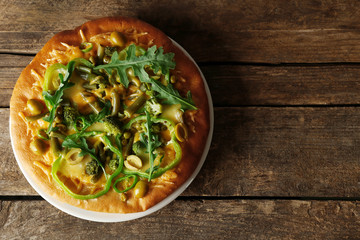 Tasty vegetarian pizza on wooden background