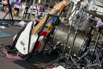 People on the terrace cafe listening to live music on the outdoor stage.Outdoor concert. Musical instruments. 