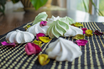 White and green marshmallow sweet composition on black backgroun