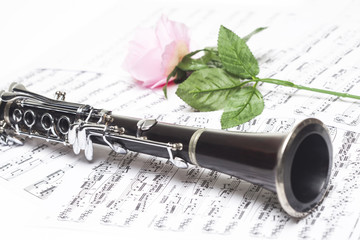 Clarinet with red rose on sheet music