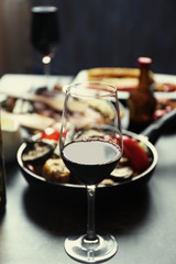 Glass of wine and grilled vegetables on served table