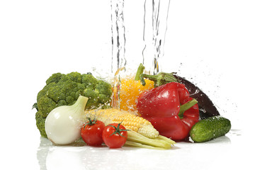 Vegetables with  splashing water on white background