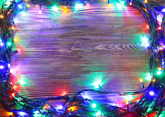 Christmas lights on a wooden background