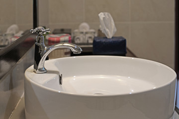 ceramic washbasin and metal faucet