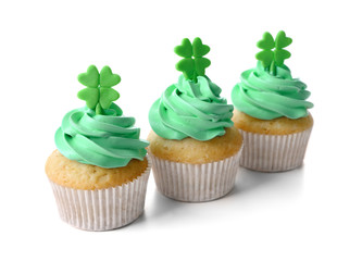 Tasty cupcakes with clover, isolated on white. Saint Patrics Day concept