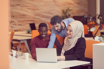 Multiracial contemporary business people working connected with technological devices like tablet and laptop, talking together - finance, business, technology concept