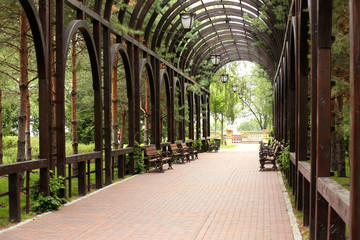 Arch tunnel with benches in park
