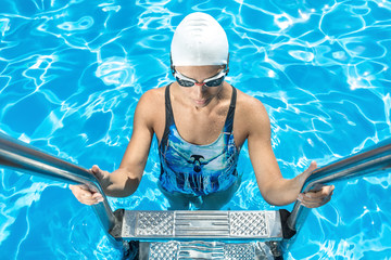 Athletic girl in the swim pool